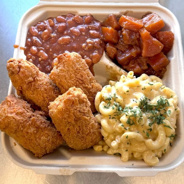 Vegan Mob's vegan BBQ plate with fried chicken, baked beans, candied yams, and mac and cheese.
