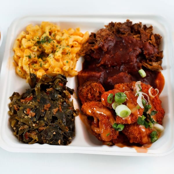 Vegan Mob's BBQ plate with mac and cheese, collard greens, and two types of vegan meat.